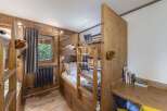 Discover the charm of this cozy bedroom featuring custom-built bunk beds, perfect for a family getaway.