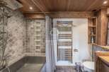 Discover the charm of this rustic bathroom, featuring a unique combination of wood and stone elements.