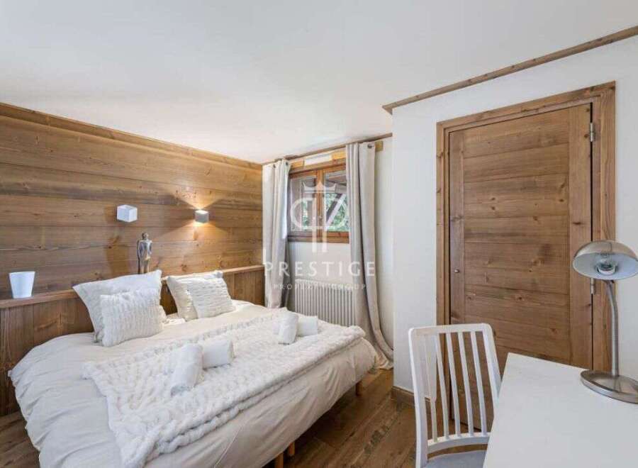 Experience the charm of this cozy bedroom, featuring a rustic wooden accent wall and a comfortable bed.