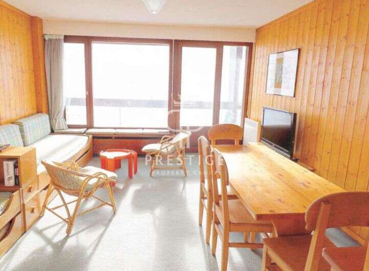 This cozy property features a bright and airy living space with large windows that offer stunning views.