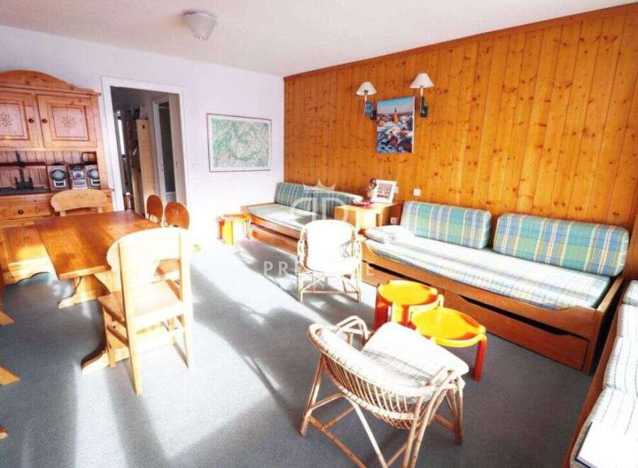 This cozy living space features a charming wooden interior, creating a warm and inviting atmosphere.