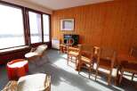 Cozy living space with natural wood paneling and ample natural light.
