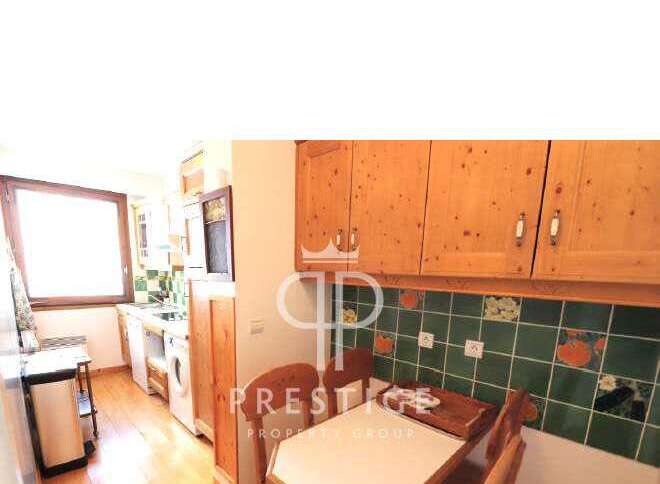 Discover this charming kitchen with wooden cabinets and a cozy dining area.