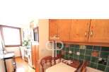 Discover this charming kitchen with wooden cabinets and a cozy dining area.