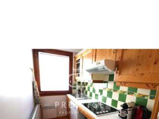 Discover this charming kitchen with wooden cabinets and a cozy atmosphere.