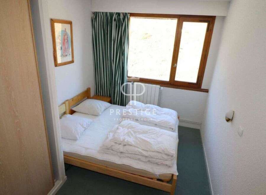 Cozy bedroom with a comfortable bed, perfect for a relaxing stay.