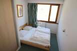 Cozy bedroom with a comfortable bed, perfect for a relaxing stay.