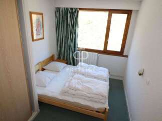 Cozy bedroom with a comfortable bed, perfect for a relaxing stay.