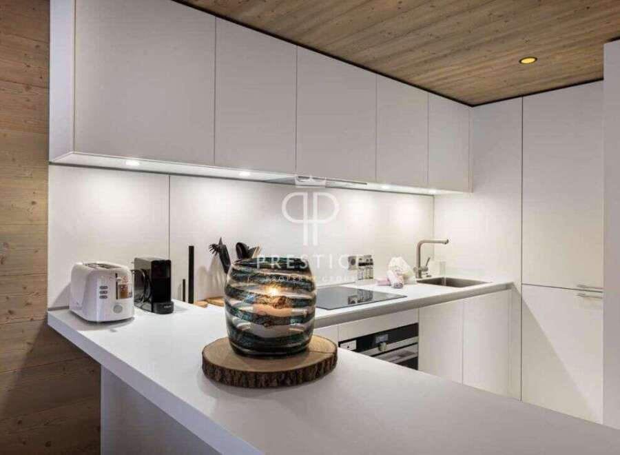 Modern kitchen design with sleek white cabinetry and a minimalist aesthetic.