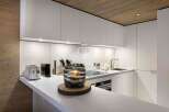 Modern kitchen design with sleek white cabinetry and a minimalist aesthetic.