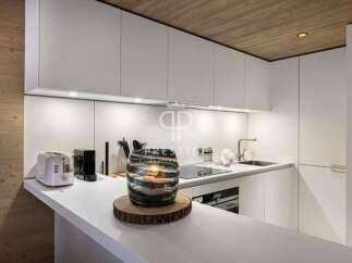 Modern kitchen design with sleek white cabinetry and a minimalist aesthetic.