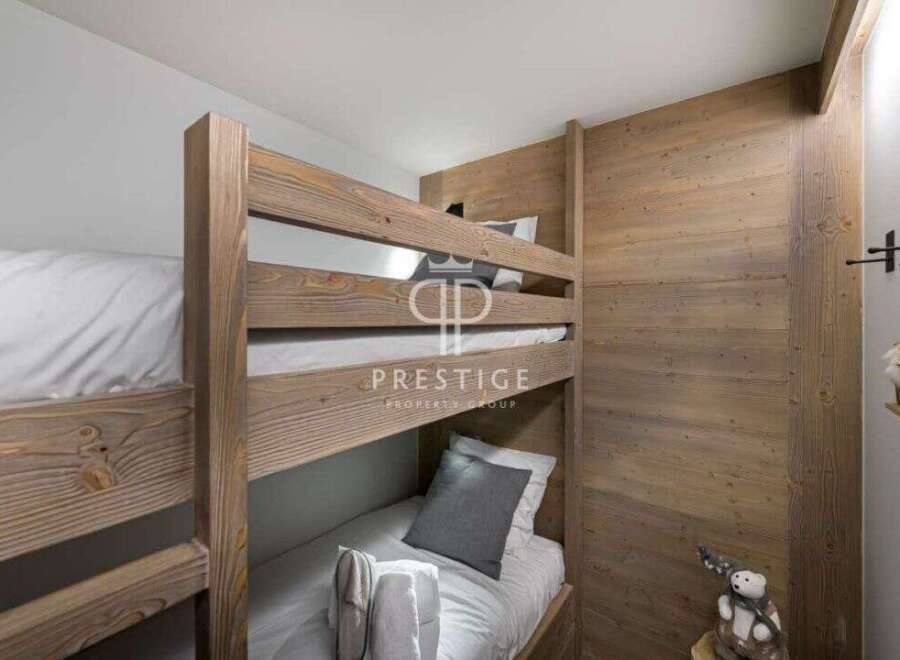 Cozy bunk beds in a rustic-style bedroom.