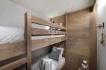 Cozy bunk beds in a rustic-style bedroom.