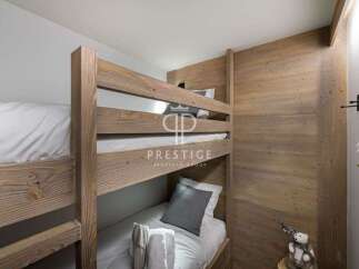 Cozy bunk beds in a rustic-style bedroom.