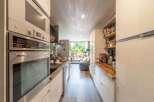 Discover a stunning kitchen with modern appliances and sleek design.