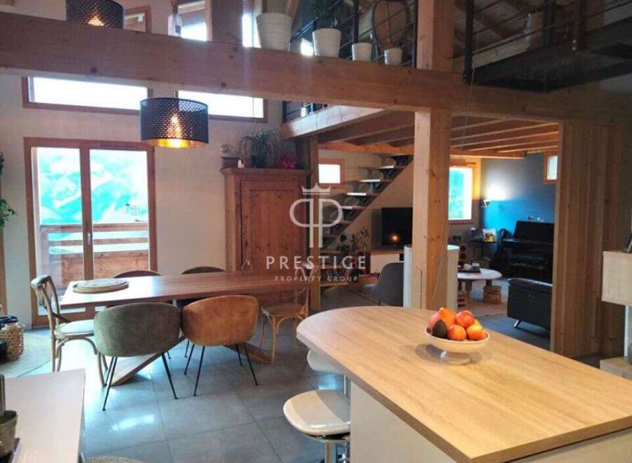 Discover the charm of this stunning property, featuring a beautifully designed kitchen with a modern island and stylish seating.