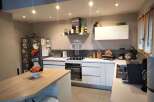 Modern kitchen with sleek white cabinetry and stainless steel appliances.