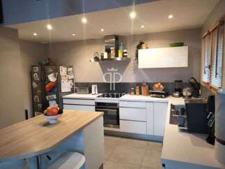 Modern kitchen with sleek white cabinetry and stainless steel appliances.