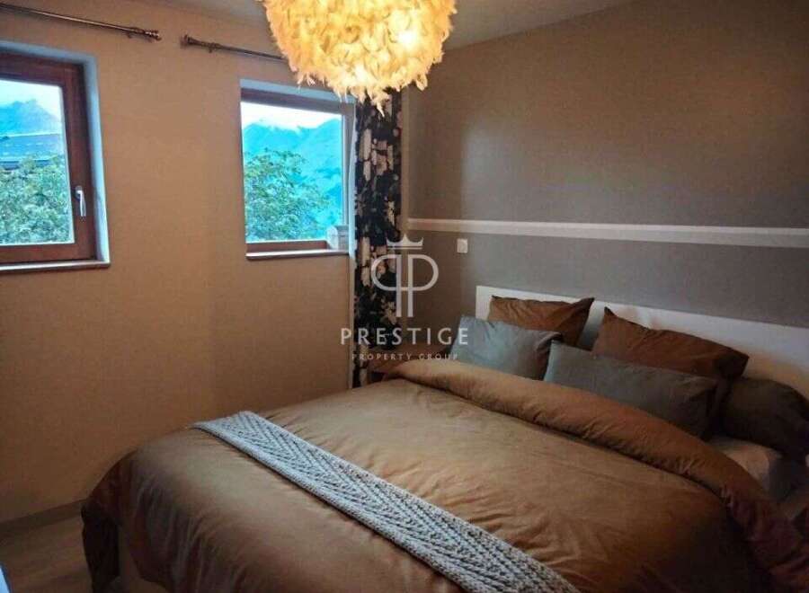 Cozy bedroom with a stunning mountain view.