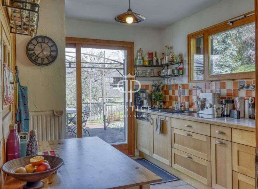 This charming kitchen boasts a rustic design with wooden cabinetry and a cozy atmosphere.