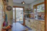 This charming kitchen boasts a rustic design with wooden cabinetry and a cozy atmosphere.