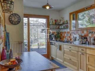 This charming kitchen boasts a rustic design with wooden cabinetry and a cozy atmosphere.