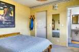 Discover this charming property featuring a cozy bedroom with a unique Gauguin artwork.