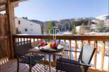 Enjoy breathtaking mountain views from this charming balcony.