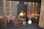 Cozy up in this luxurious lounge featuring a stunning fireplace and inviting seating.