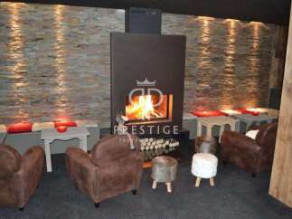 Cozy up in this luxurious lounge featuring a stunning fireplace and inviting seating.