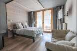 Discover a cozy bedroom retreat with a rustic wooden accent wall and a comfortable bed.