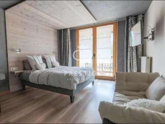 Discover a cozy bedroom retreat with a rustic wooden accent wall and a comfortable bed.
