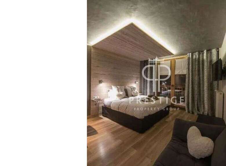 Discover a cozy bedroom with a unique wooden ceiling design.