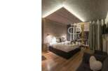 Discover a cozy bedroom with a unique wooden ceiling design.