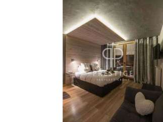 Discover a cozy bedroom with a unique wooden ceiling design.