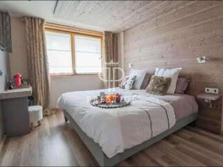 Cozy bedroom with a rustic wooden headboard and ceiling, creating a warm and inviting atmosphere.