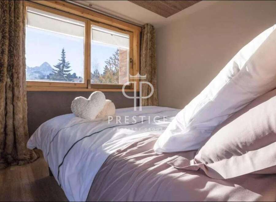 Experience luxury in this stunning bedroom with breathtaking mountain views.