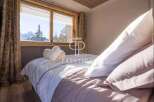 Experience luxury in this stunning bedroom with breathtaking mountain views.