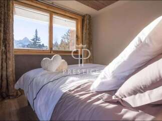 Experience luxury in this stunning bedroom with breathtaking mountain views.