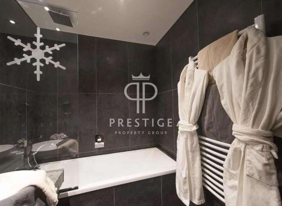 Indulge in luxury within this stunning bathroom, featuring a sleek design and modern amenities.