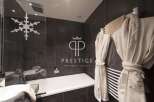 Indulge in luxury within this stunning bathroom, featuring a sleek design and modern amenities.
