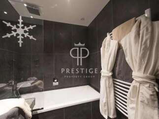 Indulge in luxury within this stunning bathroom, featuring a sleek design and modern amenities.