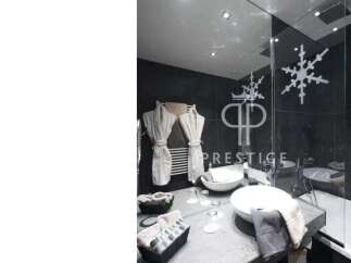 Indulge in luxury at this stunning property, featuring a modern bathroom design.