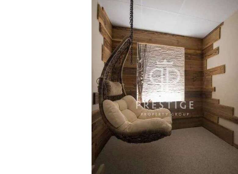Relax in style with this unique property featuring a cozy hanging chair.