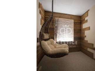 Relax in style with this unique property featuring a cozy hanging chair.