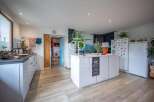 Discover this stunning kitchen with modern design and ample space.