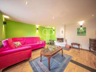 Discover this stunning property featuring a vibrant living room with a bold pink sofa and a striking green accent wall.