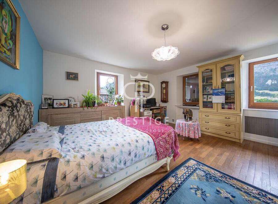 Discover the charm of this inviting bedroom, featuring a cozy bed and a touch of elegance.