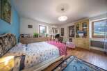 Discover the charm of this inviting bedroom, featuring a cozy bed and a touch of elegance.