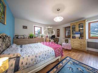 Discover the charm of this inviting bedroom, featuring a cozy bed and a touch of elegance.